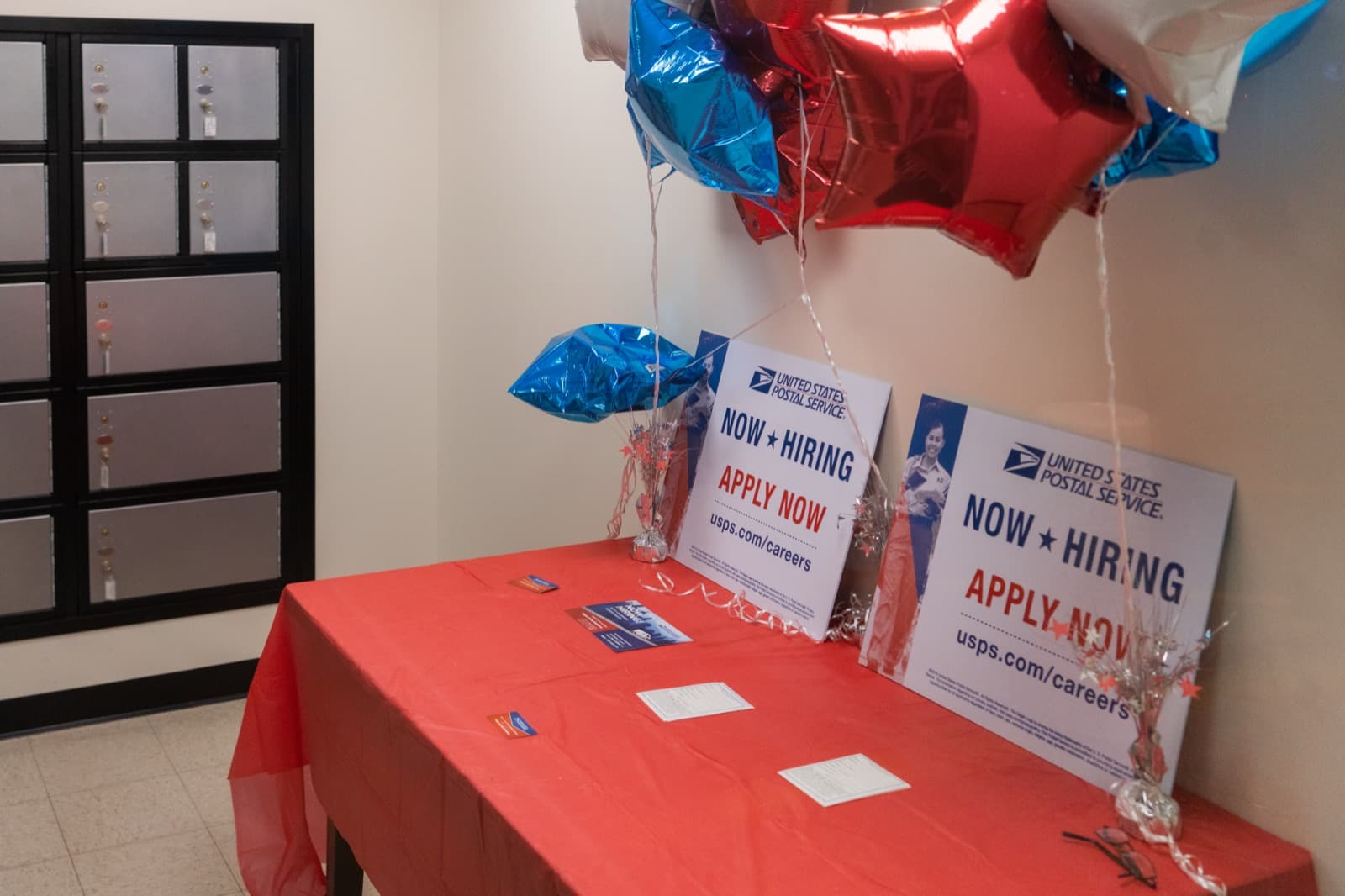 Now-hiring signs posted in a storefront window